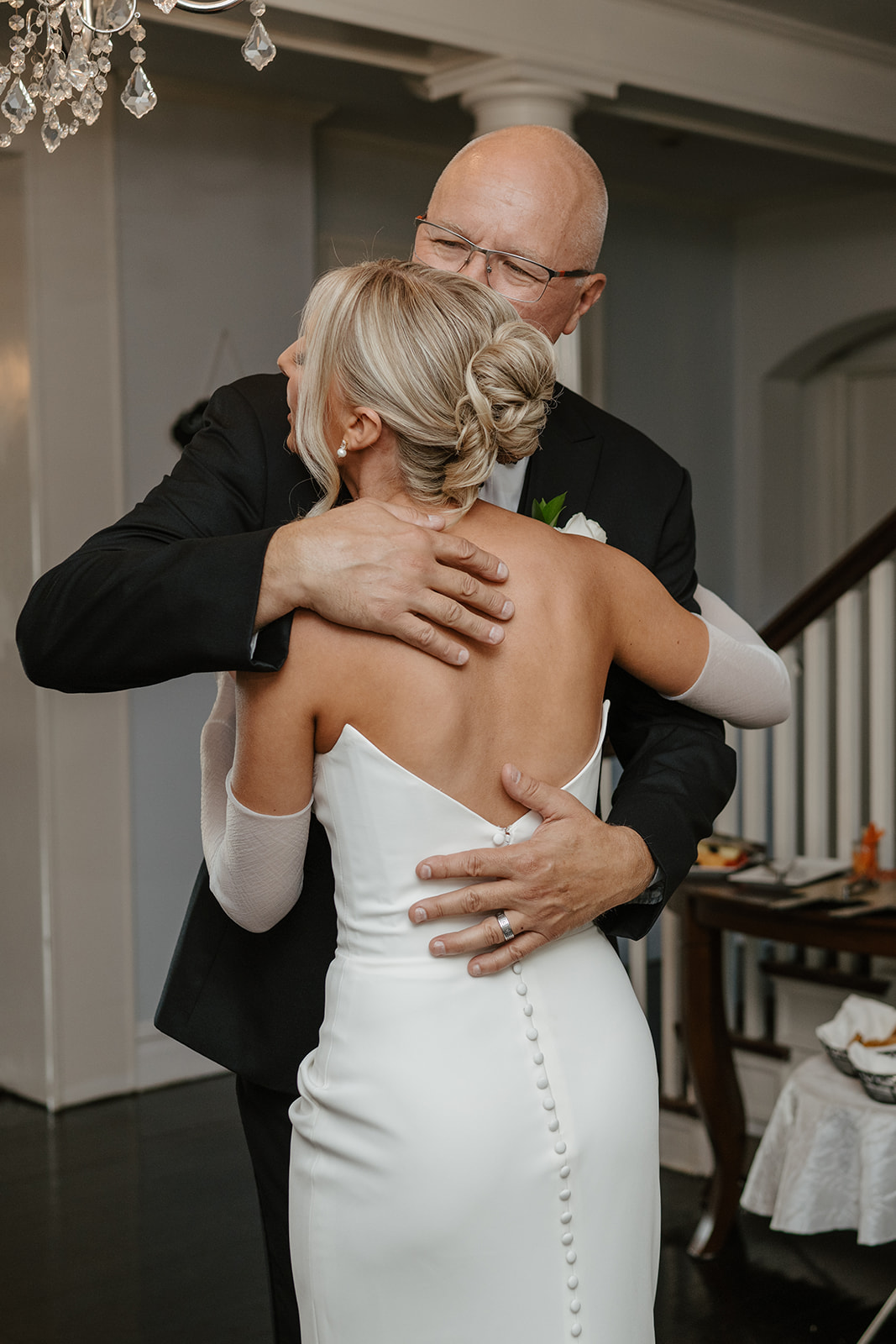 Bride shares an emotional hug with her father during their first look before the ceremony.